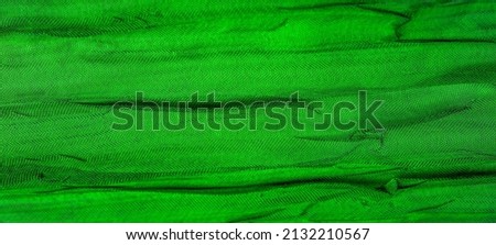 Wrinkled silk. Green color. Become an emerald beauty in this wrinkled polyester fabric! Silky smooth with a lustrous sheen, this stunning pressed designer fabric shimmers with ripples on a satin front
