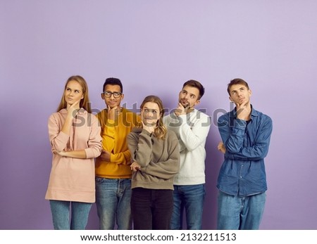 Hmm. Group of curious multiracial people with hands on chins and puzzled face expressions, look up, think hard, answer difficult question, doubt, reflect on serious problem, choose future career plans Royalty-Free Stock Photo #2132211513