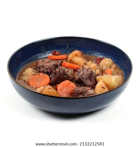 Bourguignon beef in a deep plate on a white background
