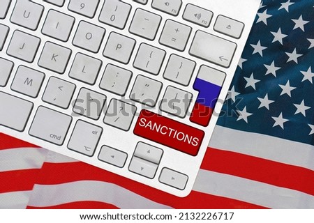 White computer keyboard with button of flag Russia and red button with word of sanctions on USA flag background. Financial and economic regulation sanctions USA against of Russia