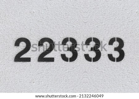 Black Number 22333 on the white wall. Spray paint.two hundred and two thousand three hundred and thirty threetwo hundred and two thousand three hundred and thirty three