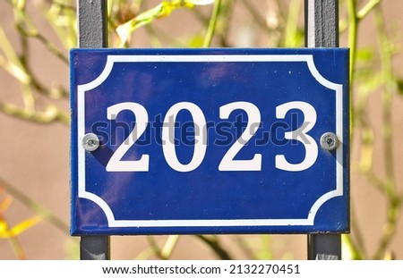 A blue house number plaque, showing the number two thousand twenty three (number 2023)
