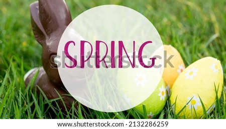 Image of spring text over easter eggs and chocolate rabbit. easter sunday and celebration concept digitally generated image.
