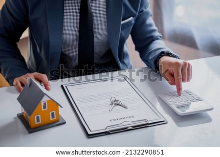 Real estate agents are analyzing insurance discounts. and make home loan decisions for customers to sign real estate purchase contract documents bank employee recommends approval for a mortgage loan