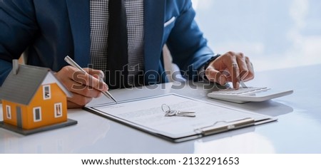Business Signing a Contract Buy - sell house, Man sign a home insurance policy on home loans, insurance agent analyzing about home investment loan Real Estate concept.