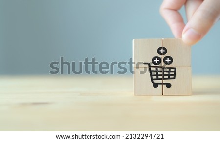 Growth of sales, average order value (AOV) concept. Sales target achievement. Increase sales in online store, e-commerce. Hand puts the wooden cubes with sales growth on grey background, copy space.  Royalty-Free Stock Photo #2132294721