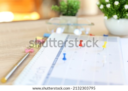 Calendar, Close-up red pin on blank desk calendar with office equipment concept of event planner or personal organization for business and appointment reminder and schedule planning.