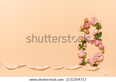 International Women's Day. Flower composition 8. Creative date. Heads of delicate roses on a light pastel beige background. Mockup postcard Mother's Day, March 8. Spring flower background, copy space