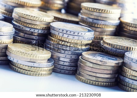 Euro coins on pile of other coins in background