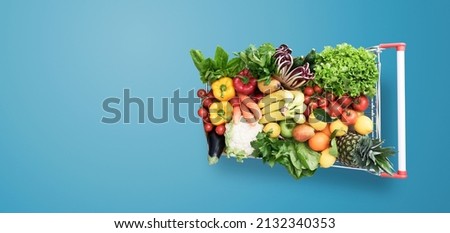 Supermarket shopping cart full of fresh vegetables and fruits, healthy organic food concept Royalty-Free Stock Photo #2132340353