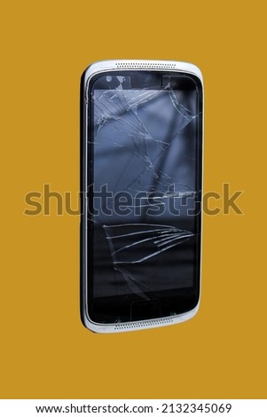Broken or damaged screen of android smartphone with simple background 