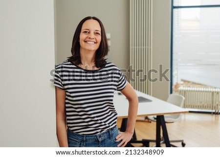 smiling woman standing in office Royalty-Free Stock Photo #2132348909