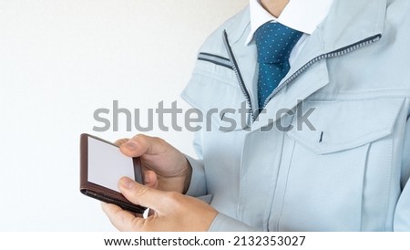 A businessman exchanging business cards. Men in work clothes.