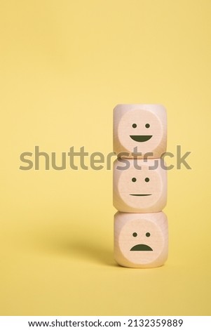 Wooden blocks with smilies faces symbols on yellow background, evaluation, Increase rating, Customer experience satisfaction. Services rating concept, copy space Royalty-Free Stock Photo #2132359889