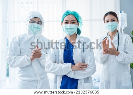 Portrait Group of Asian doctor and nurse clapping the hands with smile. Professional medical team stand in hospital office ward and giving encouragement to patient people after work in recovery room.