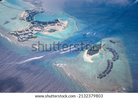 Fantastic aerial landscape, luxury tropical resort or hotel with water villas and beautiful beach scenic. Amazing bird eyes view in Maldives, landscape seascape aerial view over Maldives, traveling