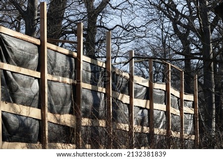 Wooden protection of construction works during the demolition of a dilapidated residential building.