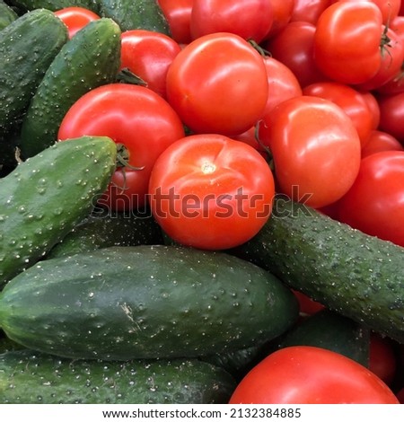 Macro photo tomato and  cucumber. Stock photo fresh green cucumbers and red tomatoes  vegetable background