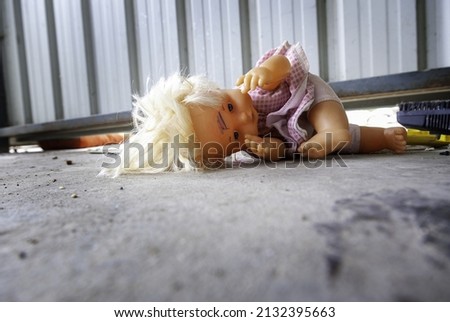 Broken doll among rubble, war childhood destroyed Royalty-Free Stock Photo #2132395663
