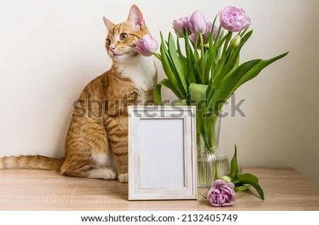 Portrait white picture frame mockup on wooden table. Modern vase with tulips.Scandinavian interior. High quality photo