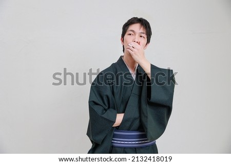 Japanese man in a kimono smoking a cigarette