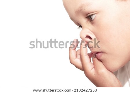 boy picking his nose with white background stock photo