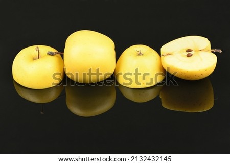 Yellow apple isolated on black mirror. High resolution photo. Full depth of field.