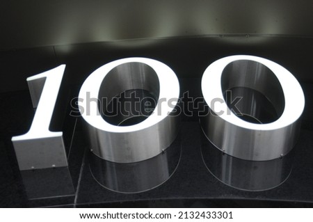 3D 100 Sign, silver and black