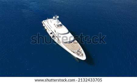 Aerial drone ultra wide photo of luxury yacht with wooden deck and helipad anchored near port of Port of Fontvieille in deep blue sea, Monaco, France