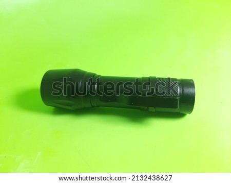 a black flashlight with a bright light when turned on, can be charged if the battery starts to get weak, the mini shape is easy to carry