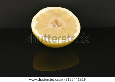 Pomelo isolated on acrylic black background. High resolution photo. Full depth of field.