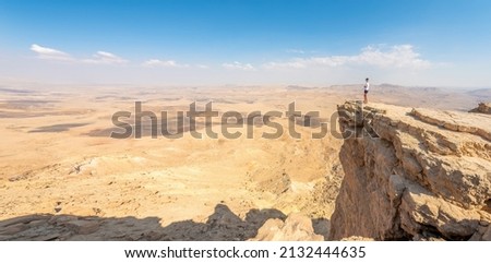 Admiring the view from Makhtesh Ramon, Ramon Crater, Negev desert, Israel. Royalty-Free Stock Photo #2132444635