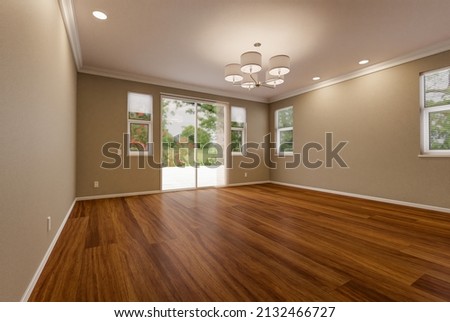 Newly Remodeled Room Of House with Finished Wood Floors, Moulding, Paint and Ceiling Lights. Royalty-Free Stock Photo #2132466727
