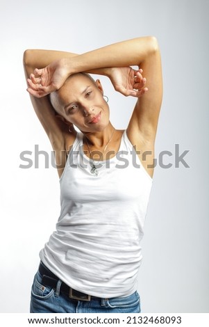 emotional studio portrait of a young attractive bald girl