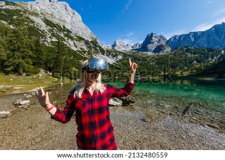 A traveler with virtual reality glasses. The concept of virtual travel around the world. In the background castle Neuschwanstein. Future technology concept.