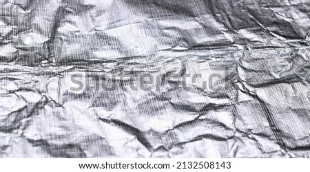 Foil silver crumpled metal aluminum texture background surface decoration backdrop design photo.