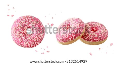 Pink glazed donut with white sprinkles and crumbs flying. Three sweet doughnuts closeup isolated on white background