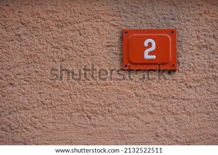 address sign hanging on the wall, two writers by number, copy space