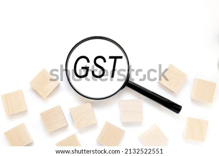 magnifying glass, with information word on white background. GST text concept.