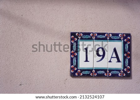 19a sign hanging on the wall, ceramic address sign