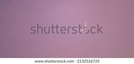 in the purple sky a beautiful crescent moon