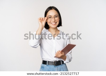 Image of young asian business woman, female entrepreneur in glasses, holding tablet and looking professional in glasses, white background Royalty-Free Stock Photo #2132527717