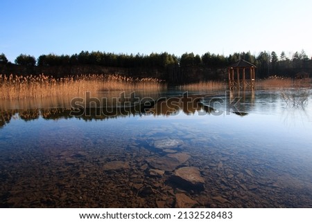 Wooden path on the pond, recultivated old flooded quarry in Jaworzno, Silesia, Poland.