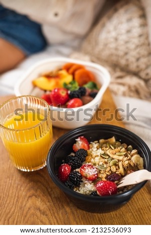 Granola for breakfast. Healthy Eating. Porridge with fruit and seeds and orange juice. A pleasant morning. Oatmeal in a bowl. High quality photo