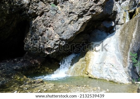 Long exposure view of a hidden river in Crimea, Ukraine. A stone set against a blurred water pattern is ideal for background use.