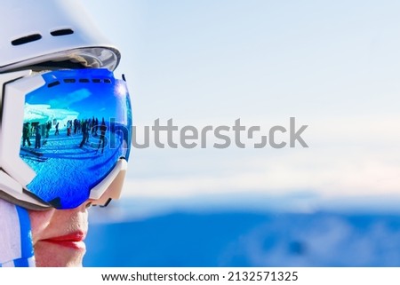 Portrait of woman in alps. woman in ski goggles at the ski resort. woman in mountain goggles. reflection in ski goggles Royalty-Free Stock Photo #2132571325