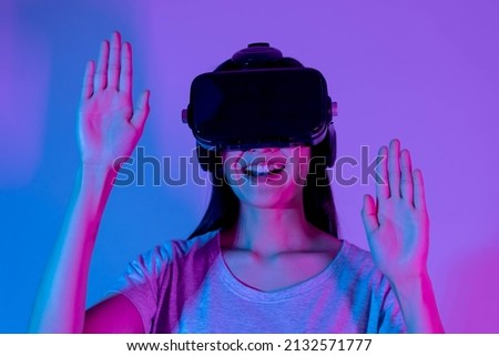 Pretty asian young woman touching air, wearing VR headset or visual reality goggles, glasses or gadget, play video game of simulator future,futuristic while wearable. Technology, isolated background.