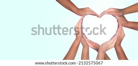 International Human Solidarity Day concept: Unity and diversity are at the heart of a diverse group of people connected together as a supportive symbol that represents a sense of teamwork.  Royalty-Free Stock Photo #2132575067