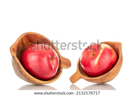 Two ripe red apples with two wood cups, macro, isolated on white background.

