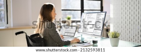 Computer Programmer Writing Program Code On Computer In Office